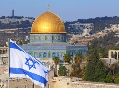 Jerusalem Old City with Dome of the Rock and flag of Israel.